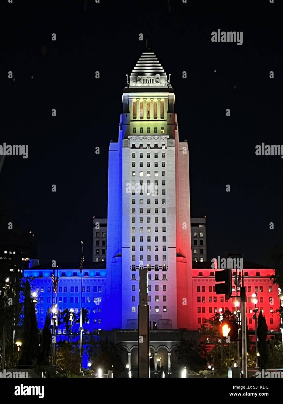 LOS ANGELES, CA, OCT 2021: close view of City Hall in Downtown at night, with blue, white and red lighting on the building - Smartphone Captured Stock Image