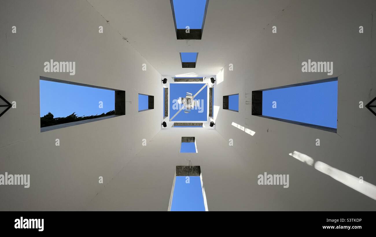 LOS ANGELES, CA, OCT 2021: blue sky through open windows, view looking up at architectural detail of building near entrance to the Skirball Cultural Center - Smartphone Captured Stock Image