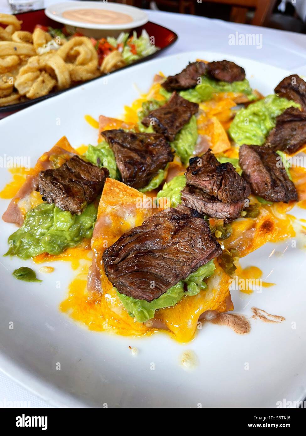 Steak nachos and fried calamari appetizers served  at an upscale Mexican restaurant Inn Midtown Manhattan, 2022, New York City, USA Stock Photo