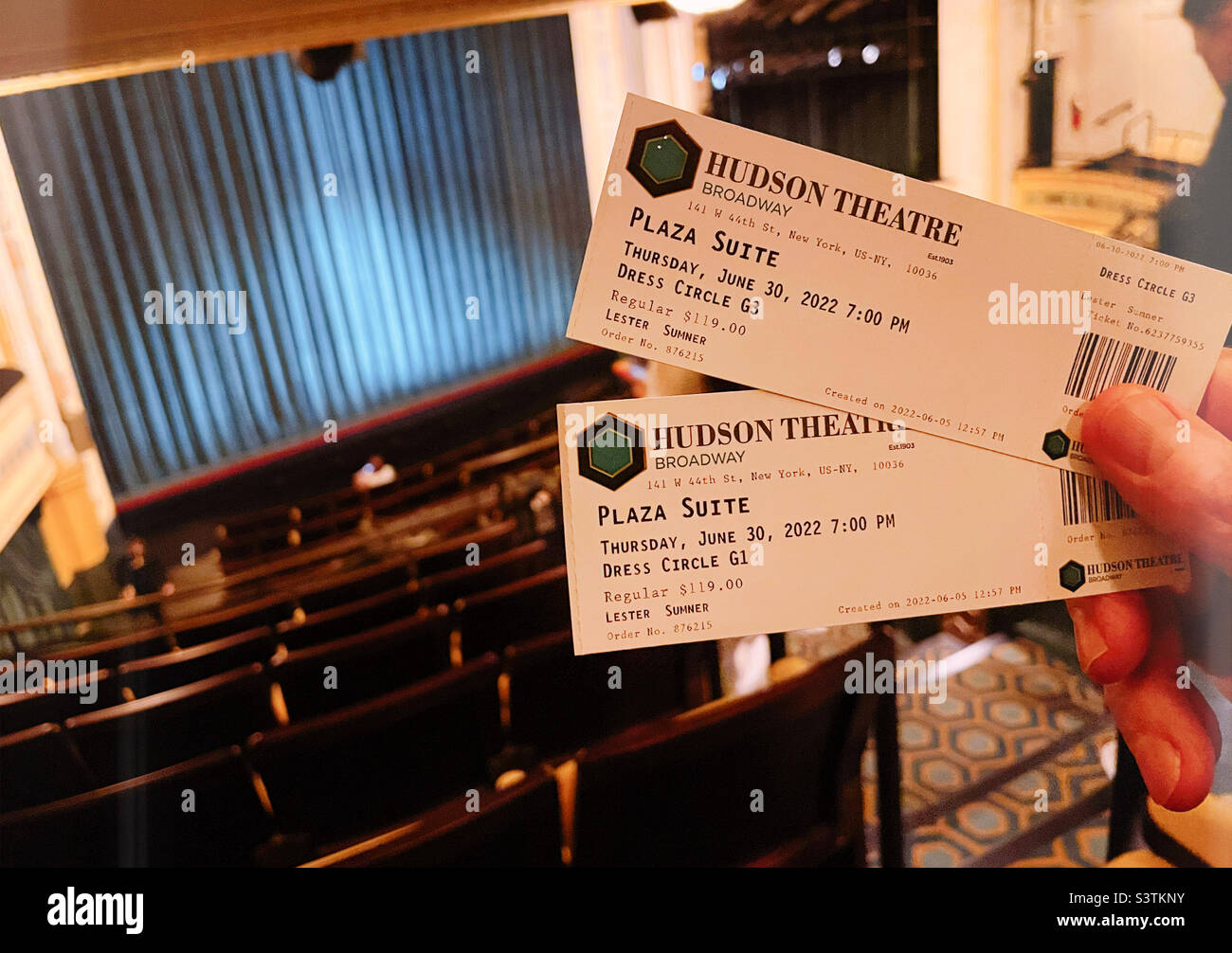 An audience member in the mezzanine of the Hudson theater holds up his tickets prior to the performance of Plaza suite, June 20 22, New York City, USA Stock Photo