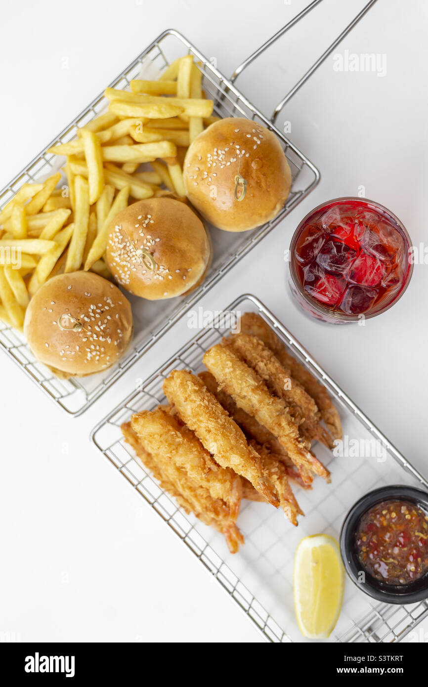 Breaded shrimps and mini burgers with French fries, delicious starters Stock Photo