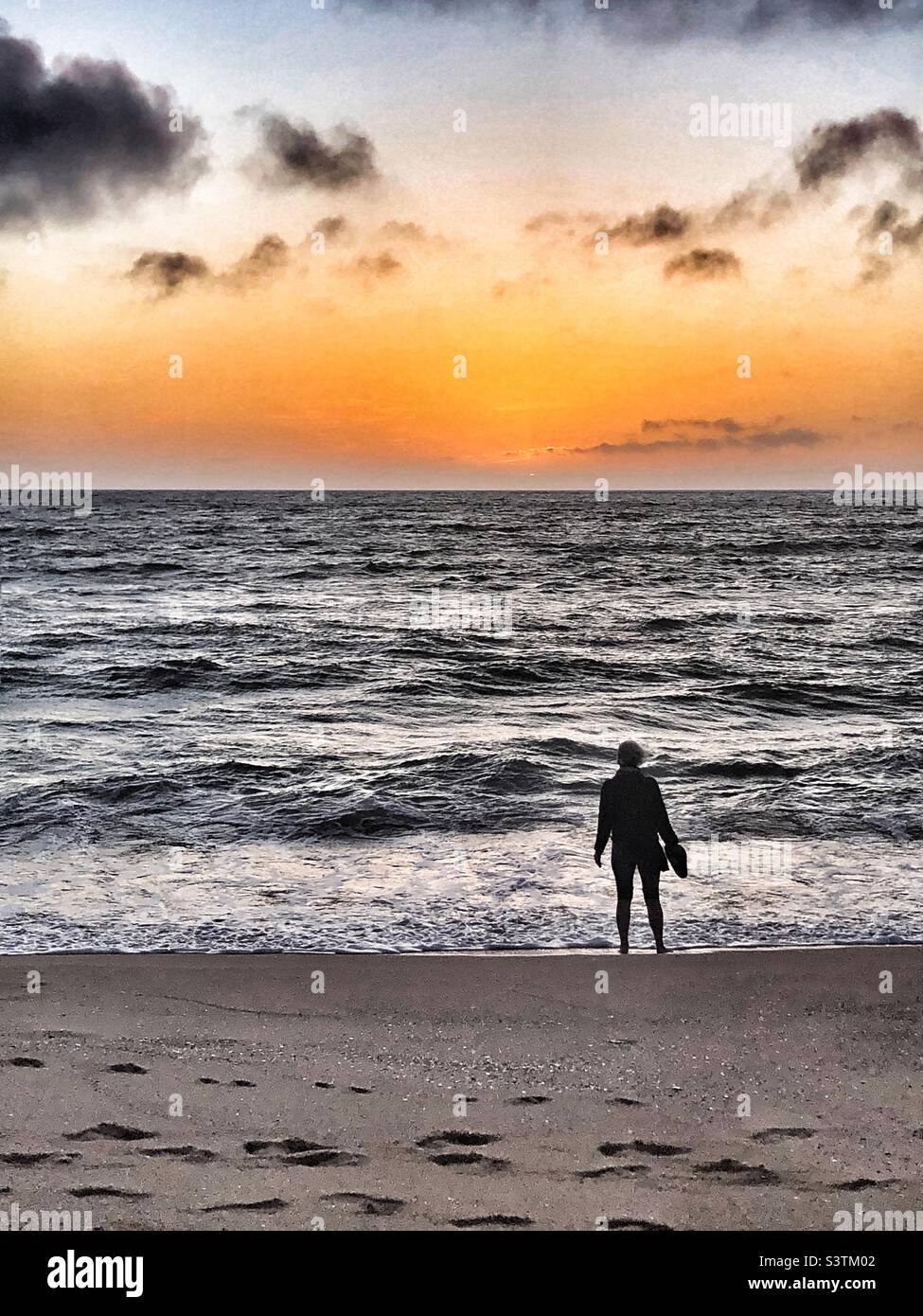 Admiring the sunset from the beach - Smartphone Captured Stock Image