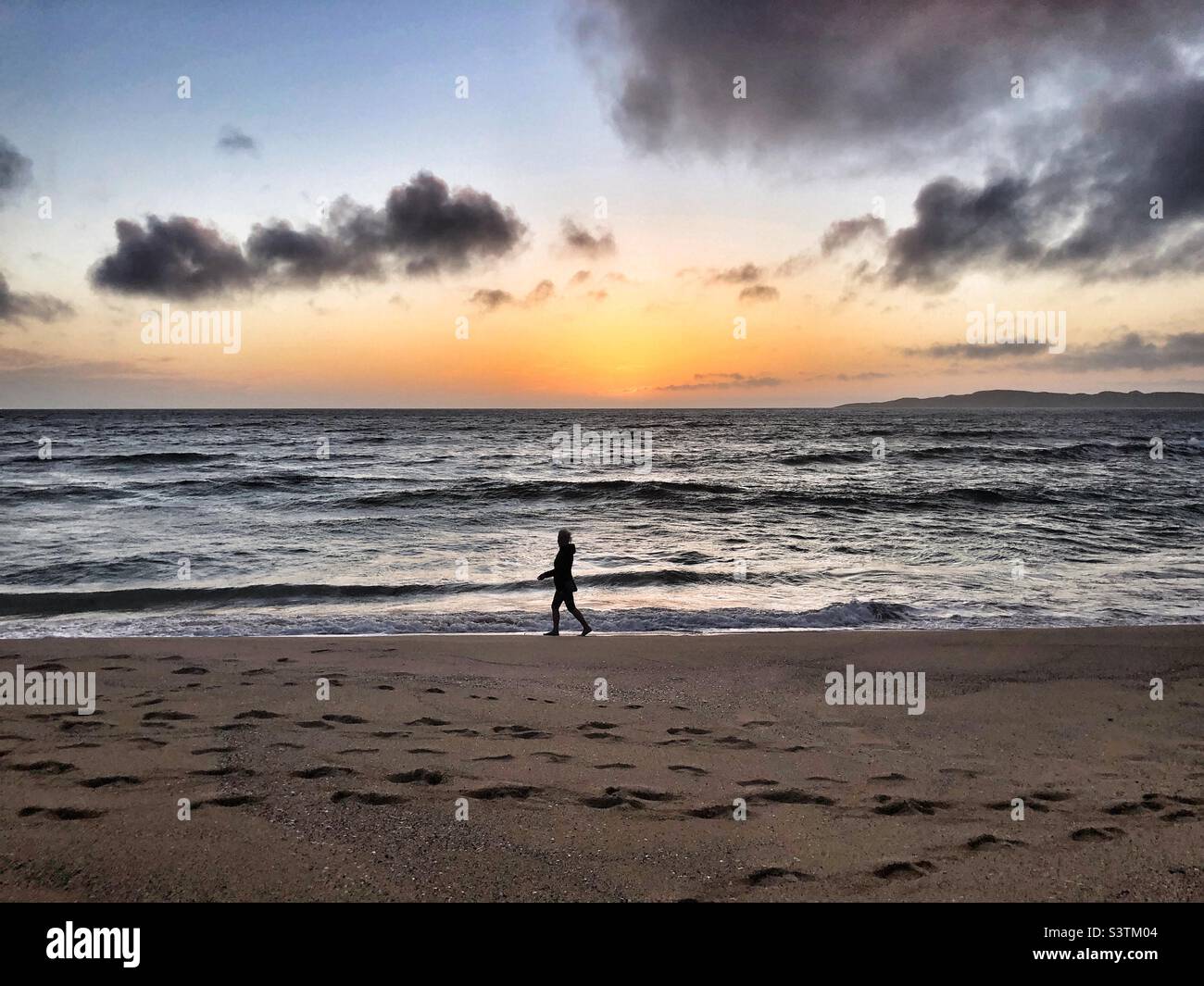 Walking on the beach at sunset - Smartphone Captured Stock Image