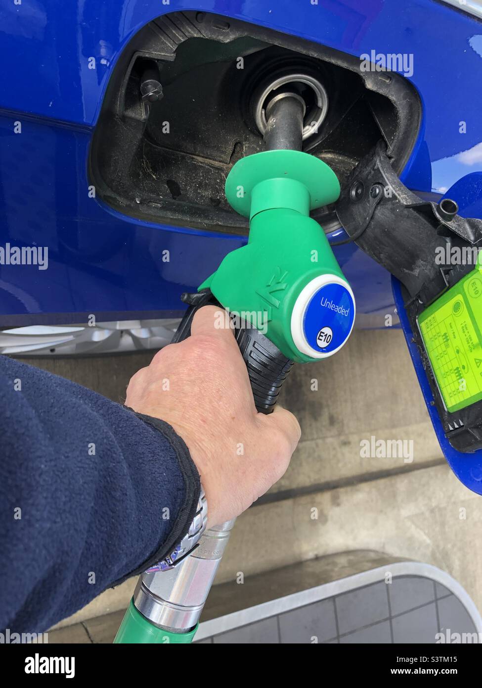 Man filling up car with unleaded petrol in the United Kingdom Stock Photo