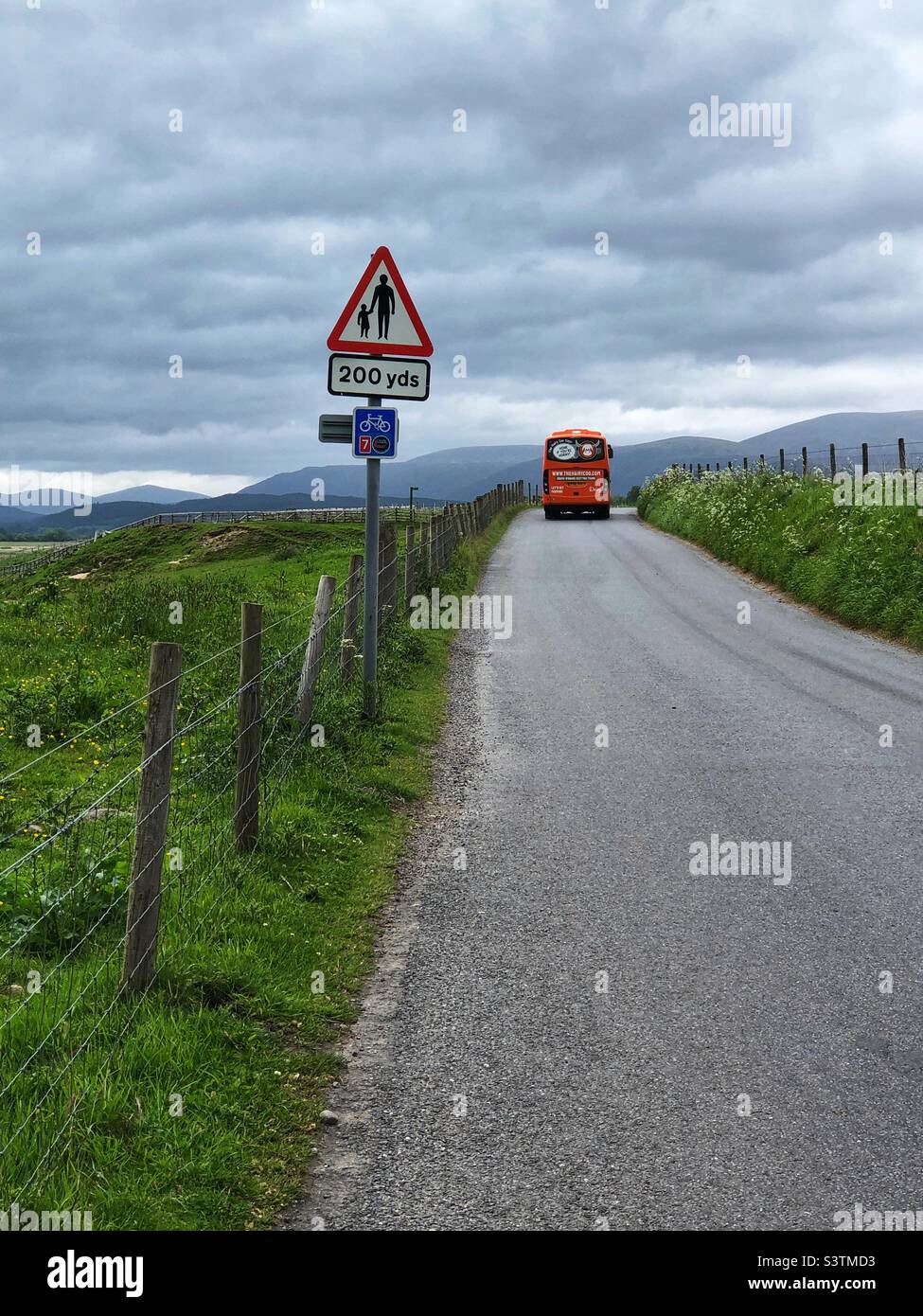 Tourist bus on a country road, Scotland - Smartphone Captured Stock Image