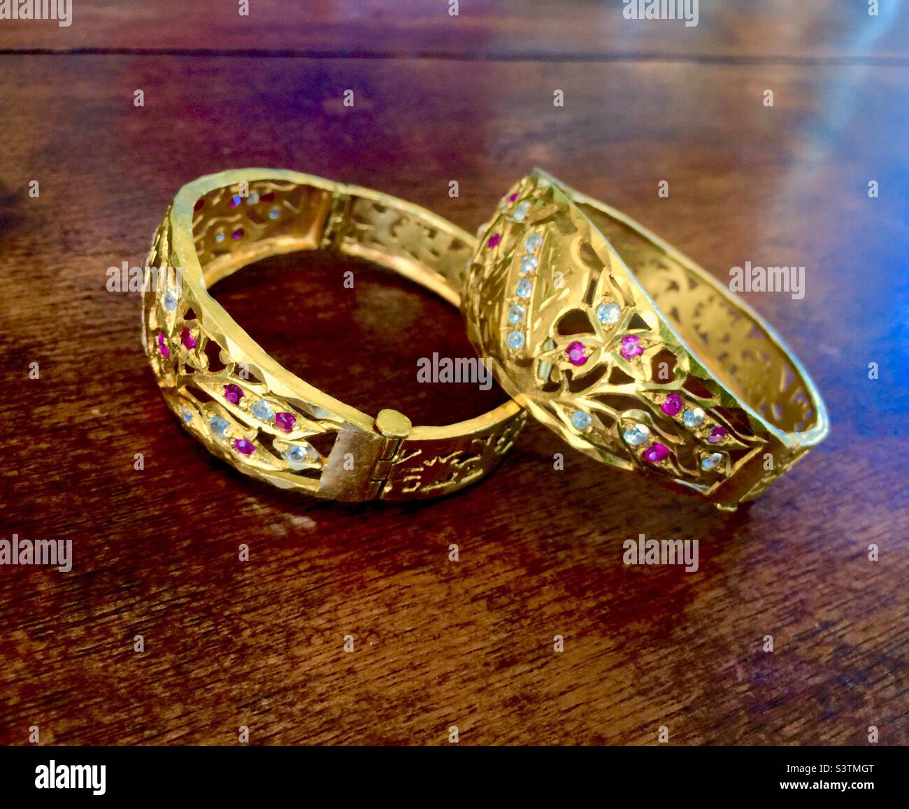 Ornate gold bracelets with precious stones Stock Photo