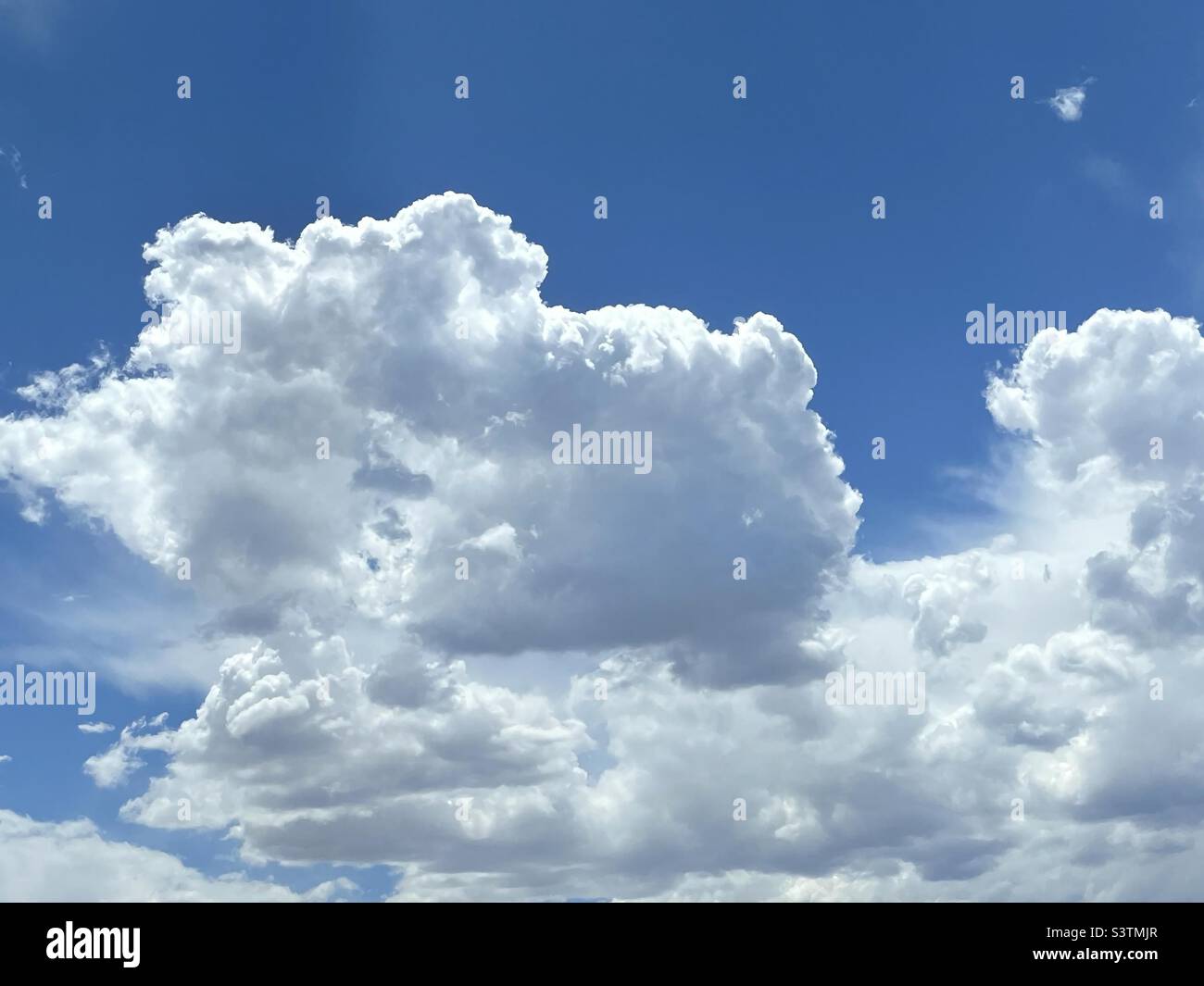 Beautiful cumulus clouds decorate the skies over the Salt Lake valley in Utah, USA in July on a nice summer day. - Smartphone Captured Stock Image