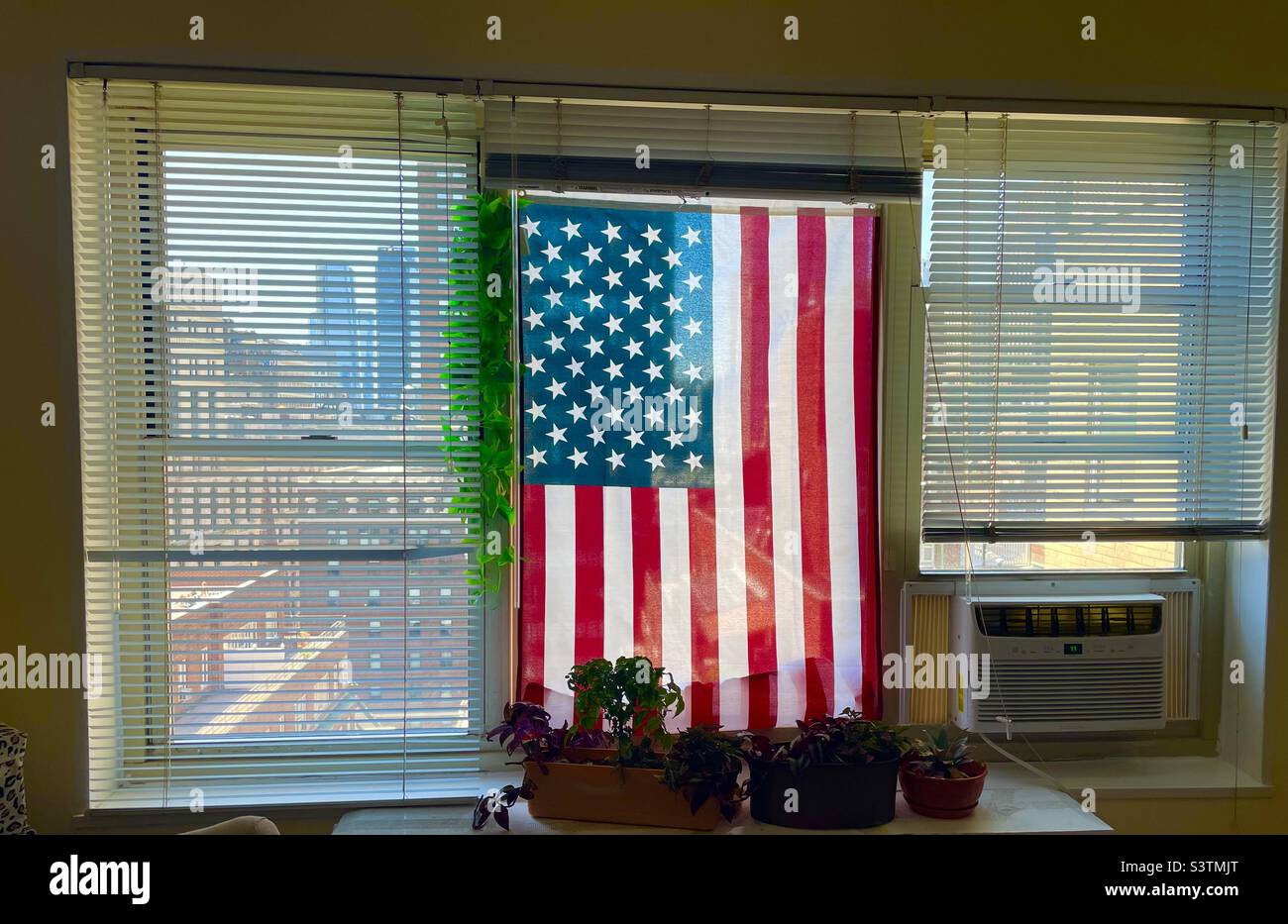 American flag hanging in the window of a New York City apartment Stock