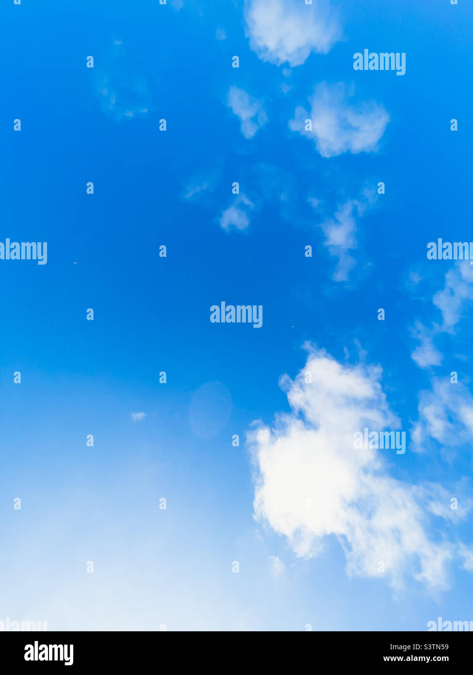 Blue sky with scattered white clouds on a sunny summer day Stock Photo ...