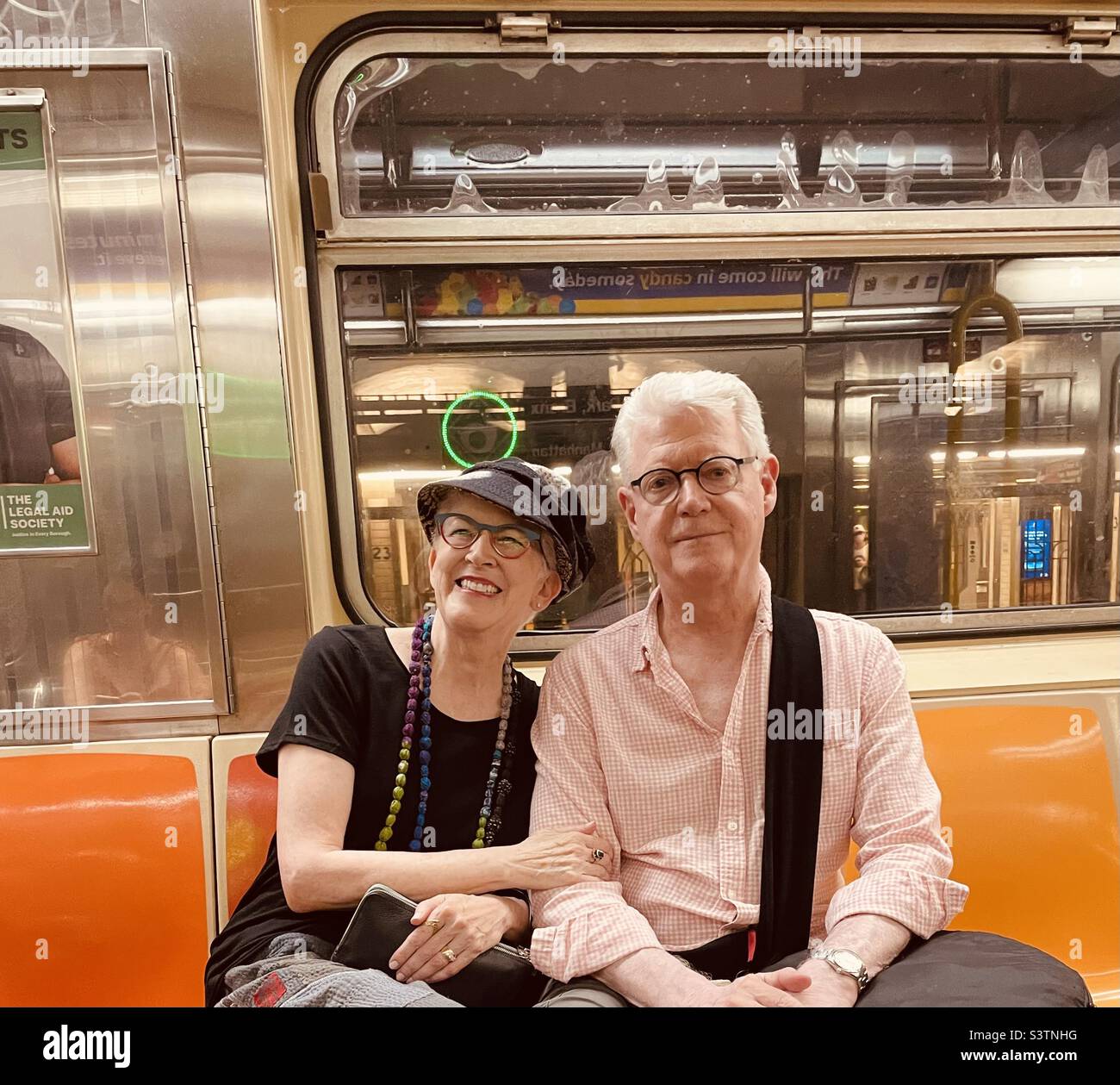 Hey smiling couple on a New York subway train - Smartphone Captured Stock Image