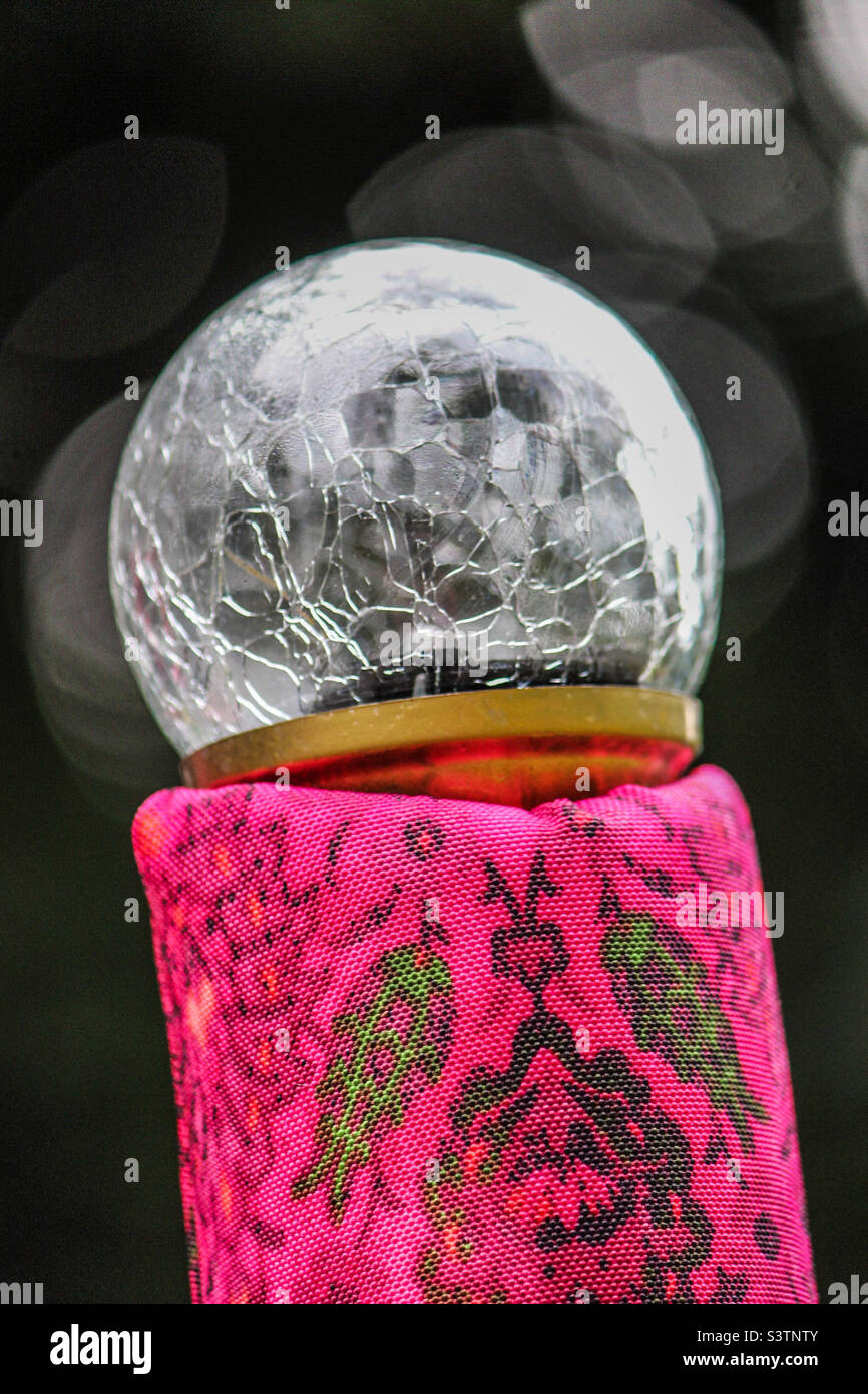 Pink fabric with cracked globe attached to it. Stock Photo