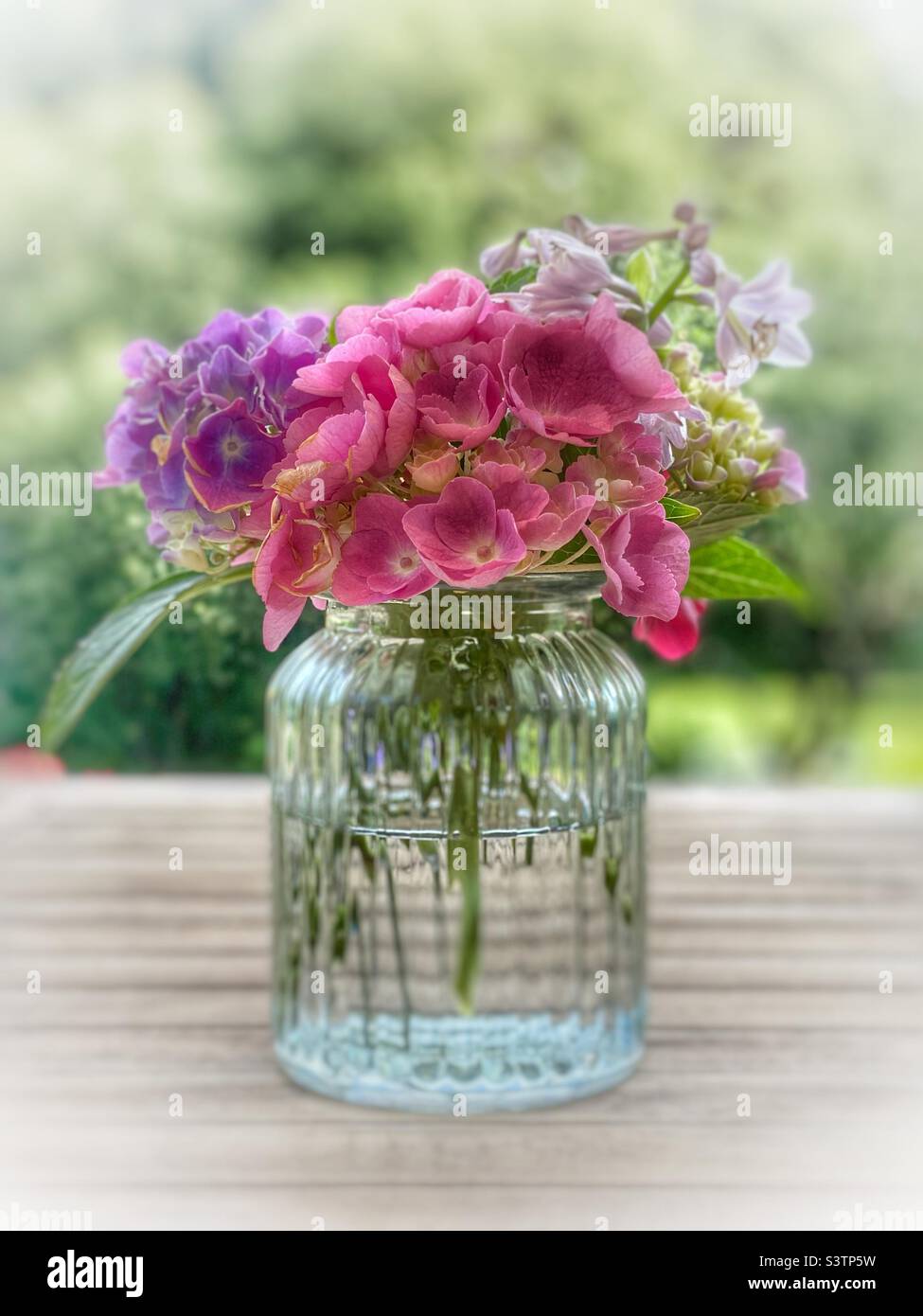 Vase of flowers outside Stock Photo