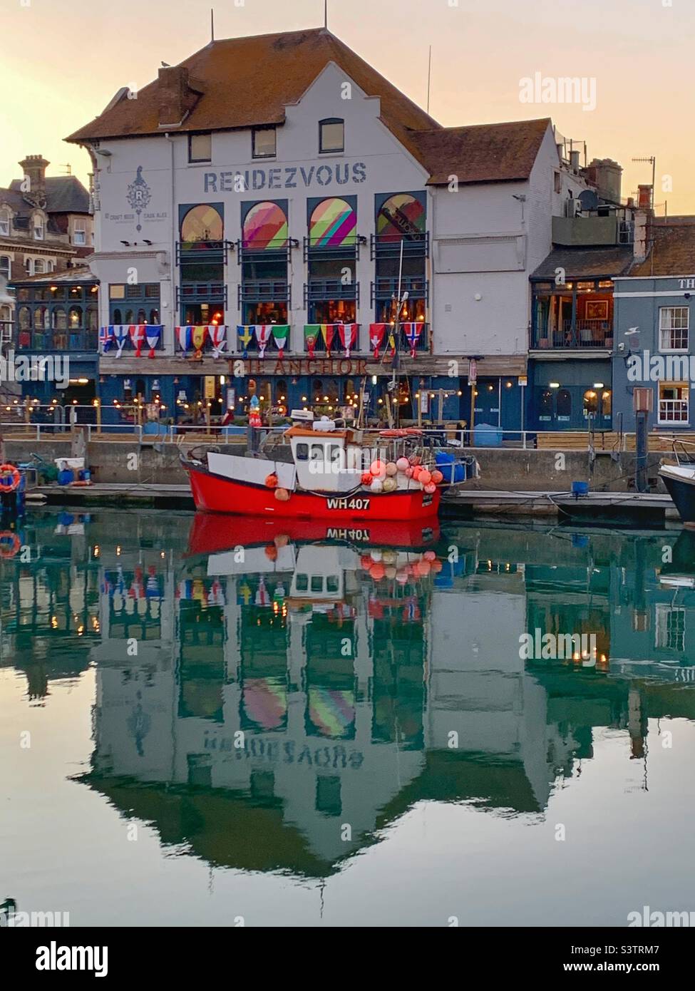 Weymouth harbour reflection of rendezvous pub Stock Photo