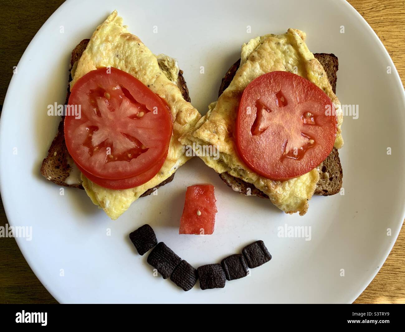 Multi grain and scramble eggs for breakfast, smiley design - Smartphone Captured Stock Image