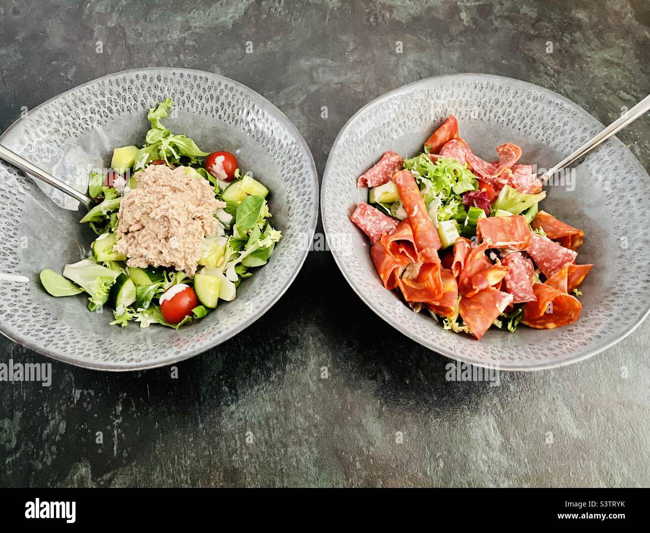 Lunch Date. Tuna salad and cured meat salad. Stock Photo