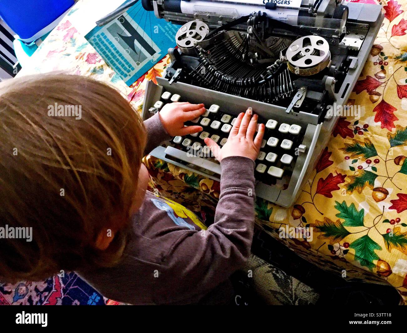 Today’s toddler tries grandpa’s technology, a manual typewriter, Ontario, Canada. - Smartphone Captured Stock Image