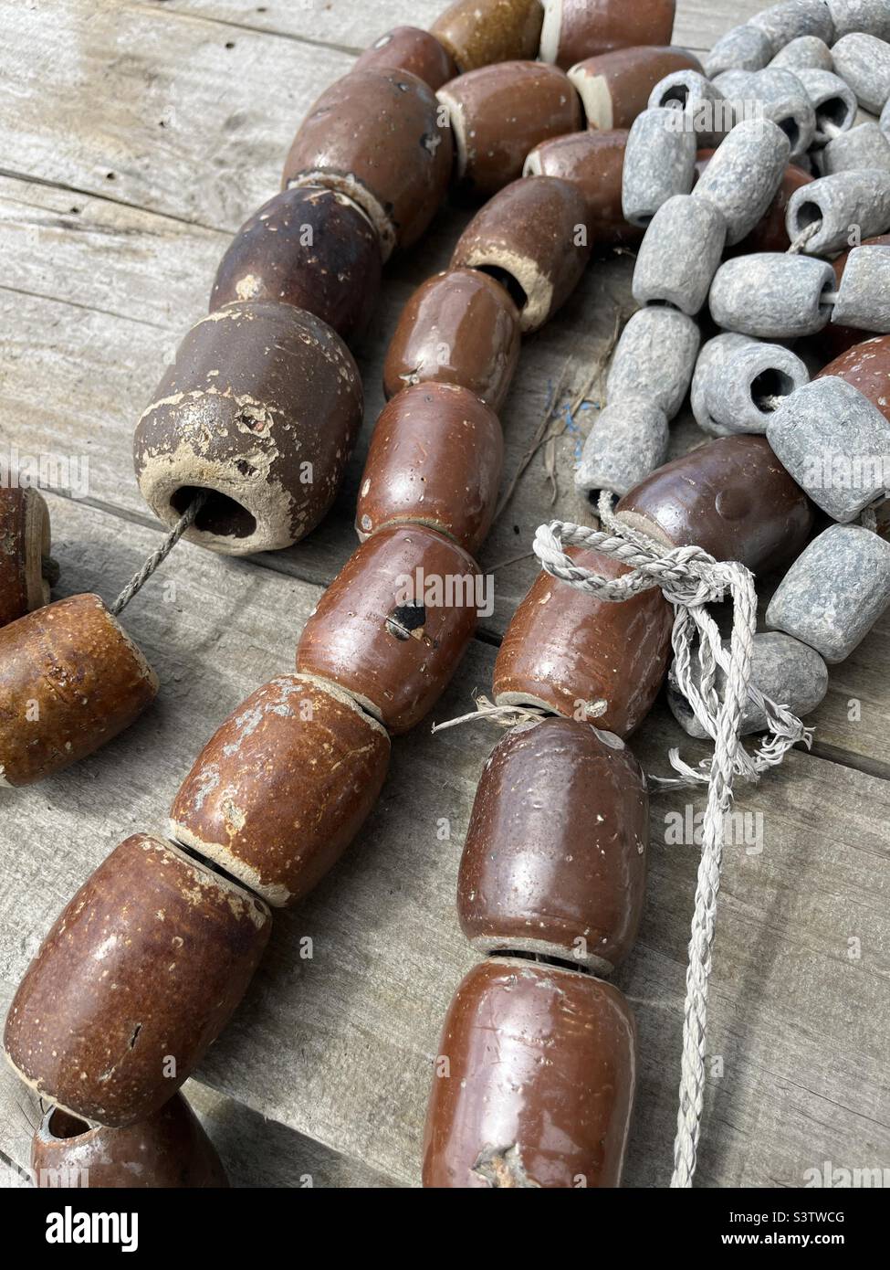 Strings of Japanese ceramic and lead fishing weights - Smartphone Captured Stock Image