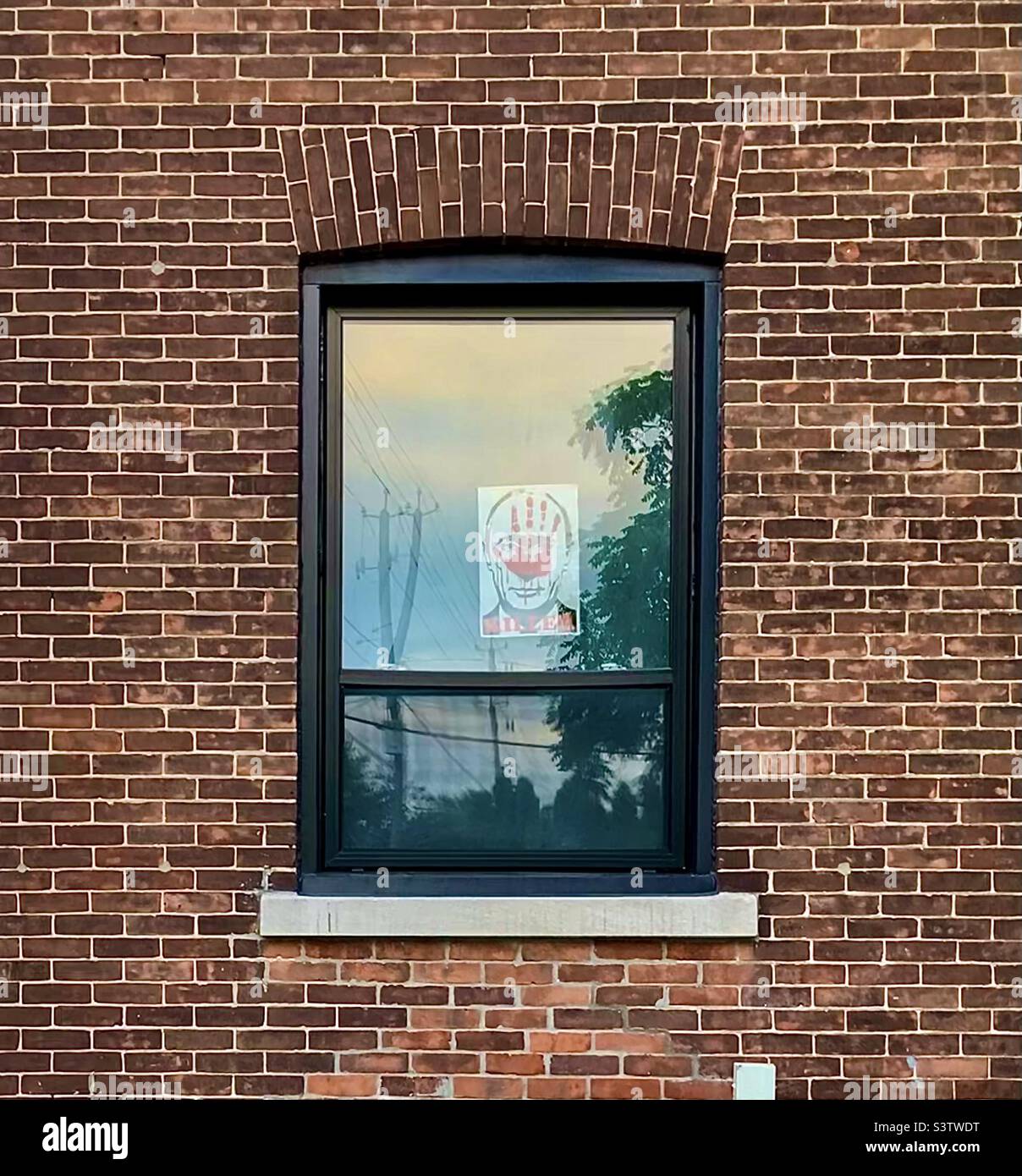 Anti-Putin poster in brick house window. Stock Photo