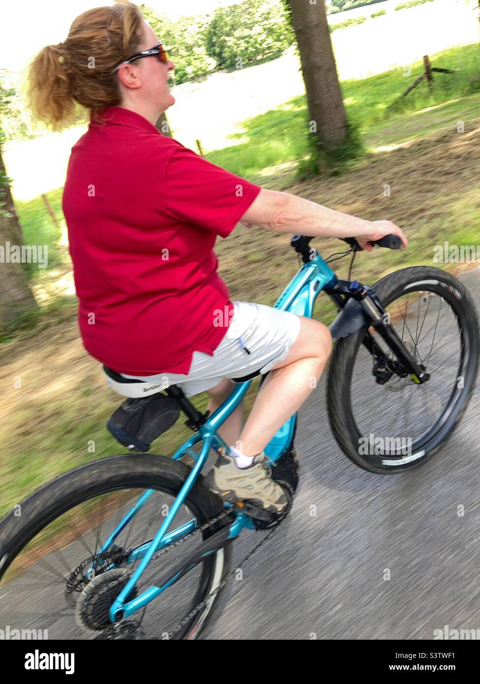 Woman riding an e-bike Stock Photo