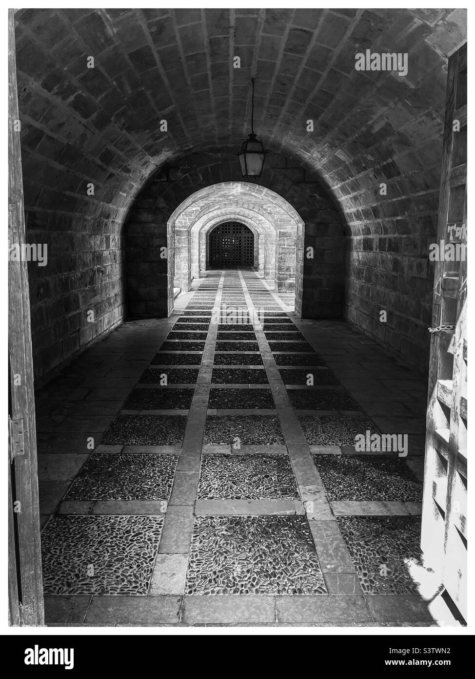 Tunnel through an archway Stock Photo