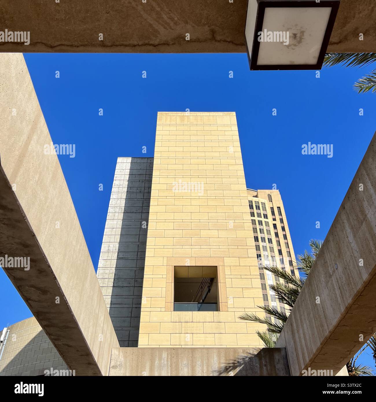LOS ANGELES, CA, DEC 2021: view looking up at office building with deep blue sky behind, at Union Station in Downtown - Smartphone Captured Stock Image