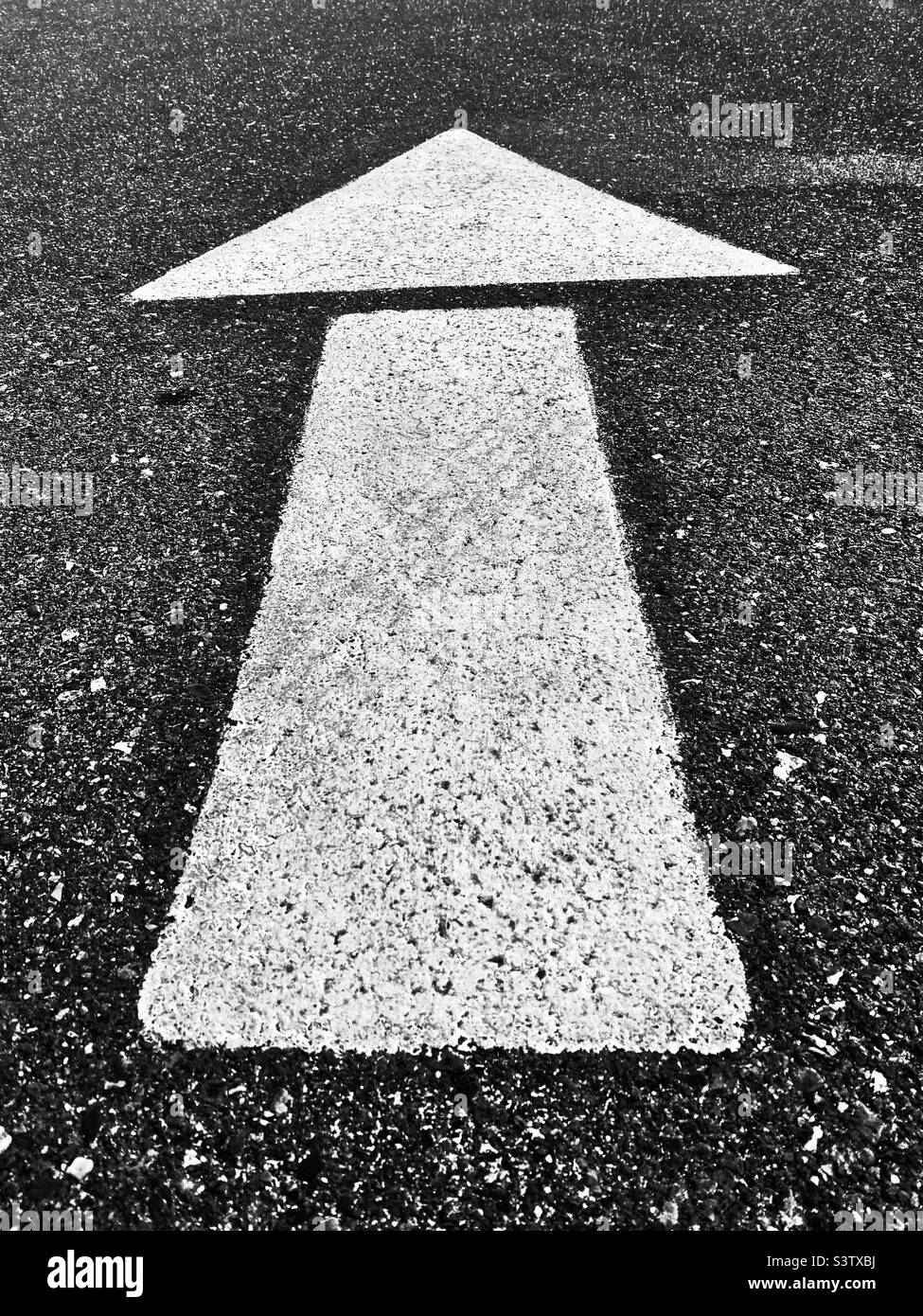 White arrow on pavement - Smartphone Captured Stock Image