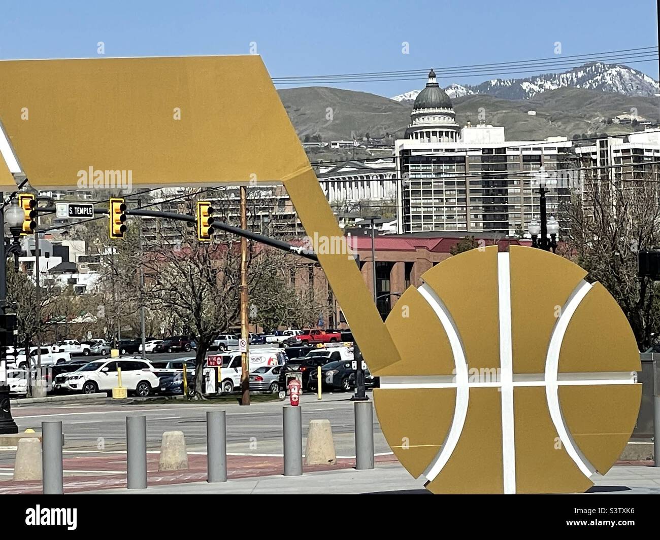 Large Utah Jazz basketball logo sets in front of the Vivint Arena, the home of The Utah Jazz in SLC, Utah, USA. Taken from behind the logo, you can see part of the downtown area and the State Capitol. Stock Photo