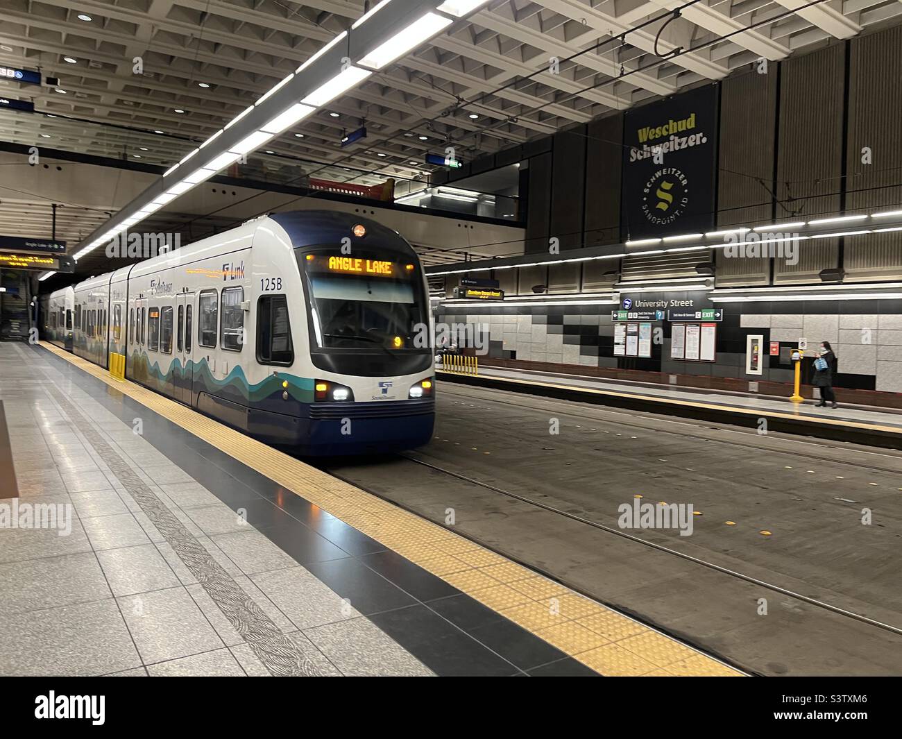 SEATTLE, WA, DEC 2021: modern train pulling into University Street station on light rail system in Downtown Stock Photo