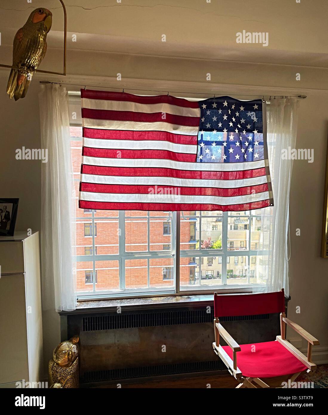 The American flag proudly displayed in an apartment window in New York City over the Fourth of July weekend, 2022, USA Stock Photo