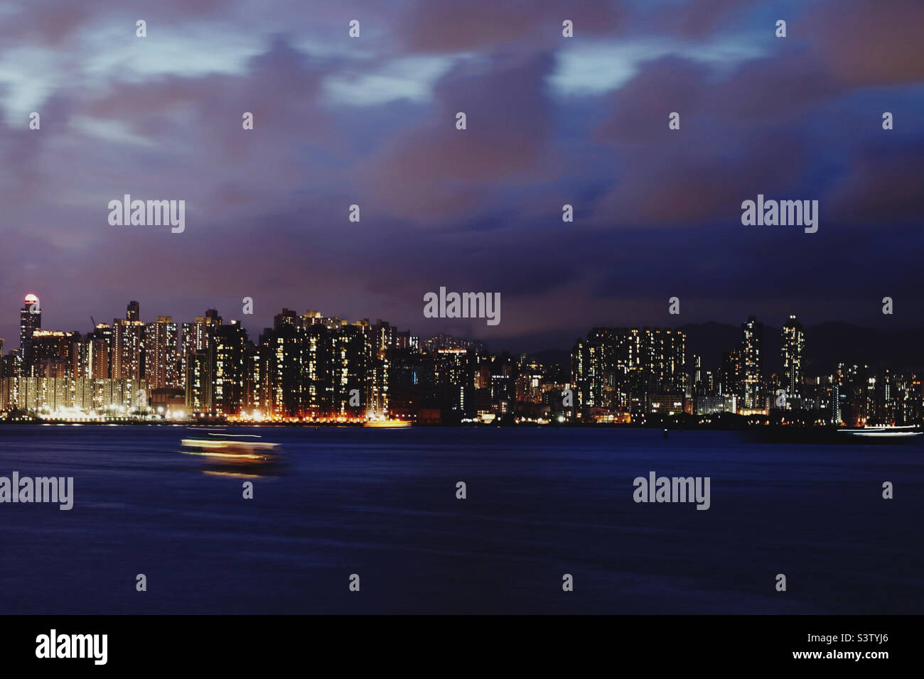 Blue hour harbour view with motion blur speedboat - Smartphone Captured Stock Image