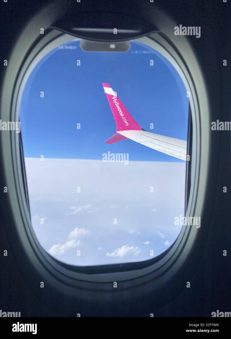 Up above the clouds with Swoop airlines. - Smartphone Captured Stock Image