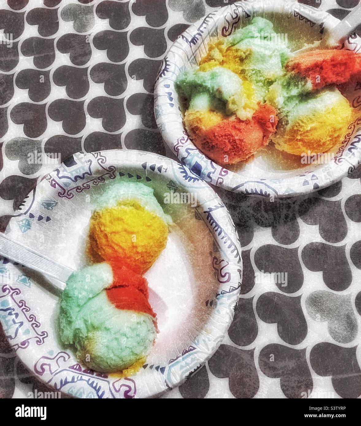 Rainbow Sherbet ice cream set upon a kitchen tabletop in a home in Utah, USA. Color selection and grunge effects digitally added. - Smartphone Captured Stock Image