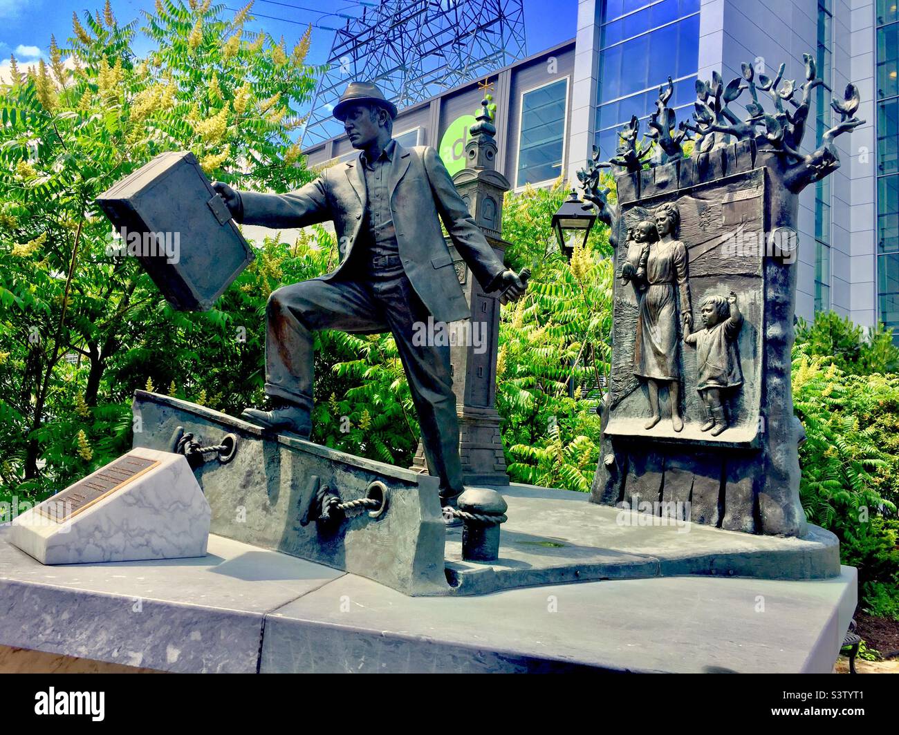 Immigration to America, commemorative sculpture at Pier 21, Halifax, Canada. Man with suitcase. Family in tow. Stock Photo