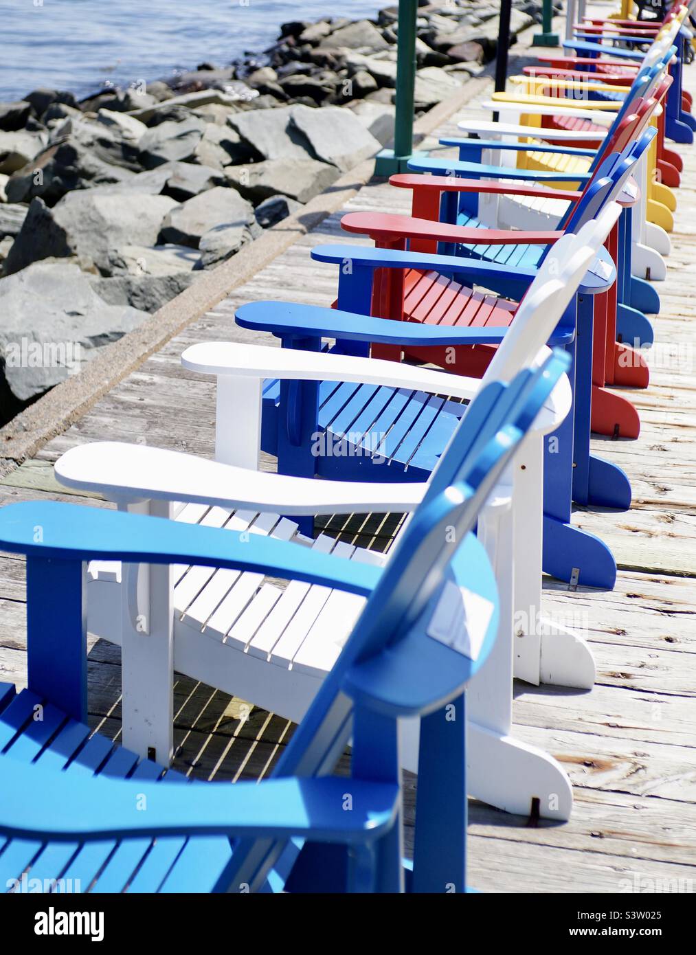 Colourful Muskoka chairs looking out onto Halifax Harbour. - Smartphone Captured Stock Image