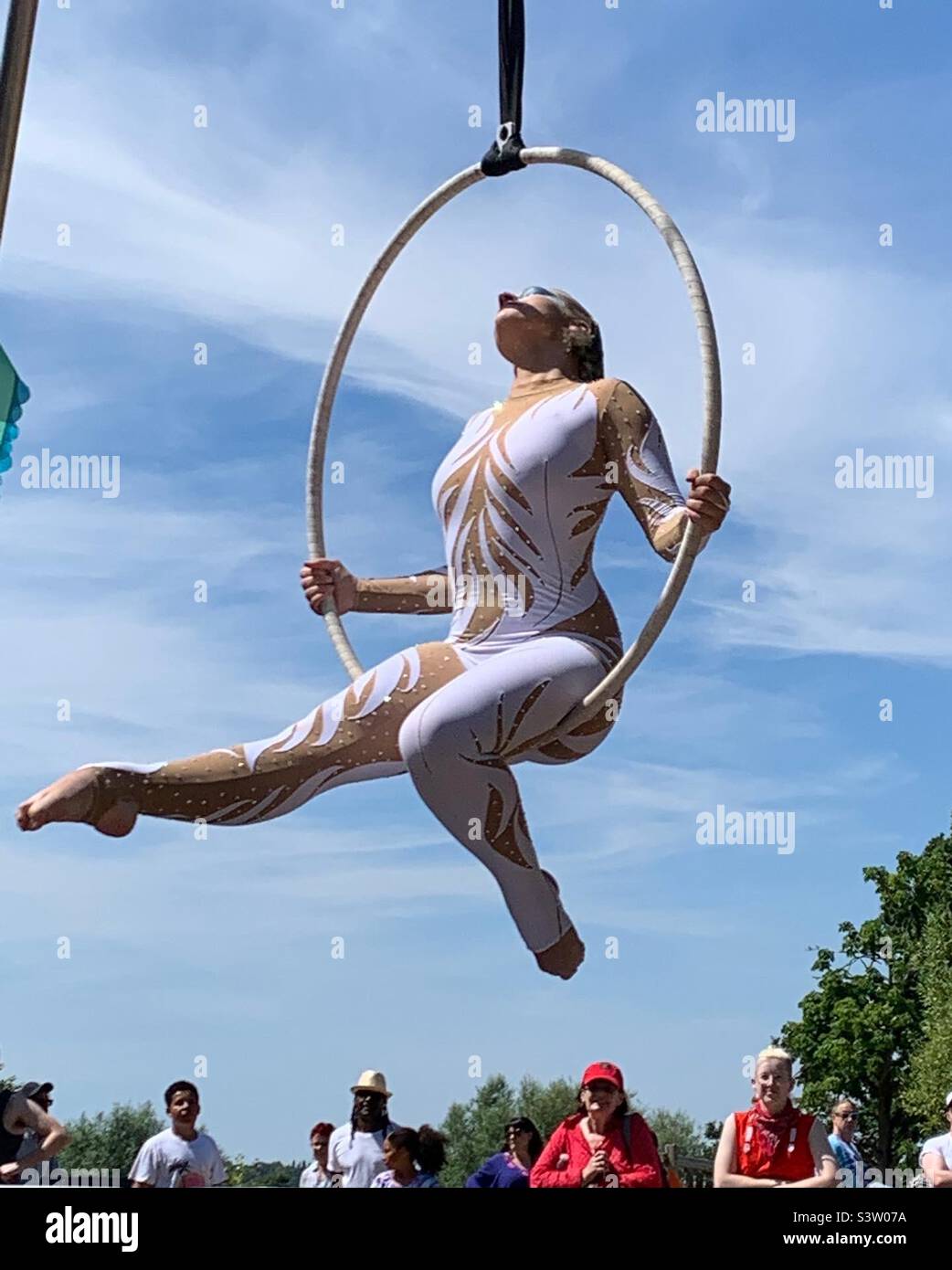 Female performer on suspended hula hoop Stock Photo