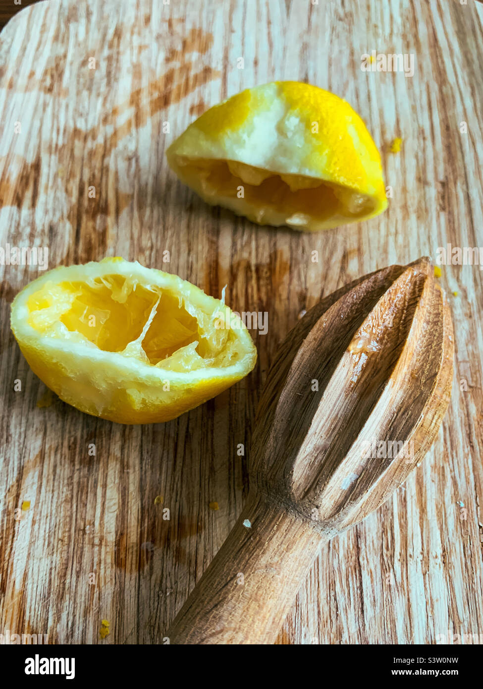 Lemons zested and juiced by a wooden reamer Stock Photo Alamy