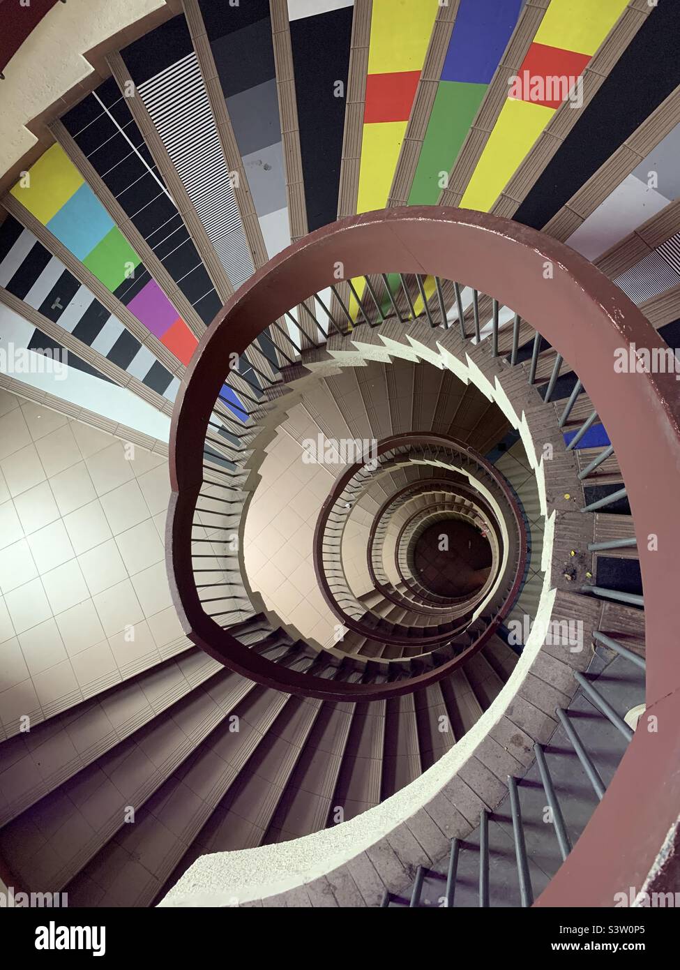 Spiral staircase with colorful steps like TV test pattern Stock Photo