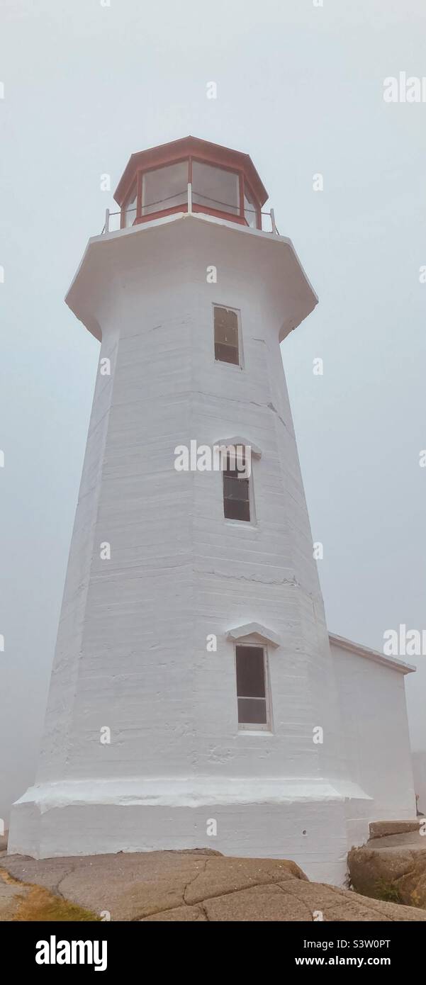 Peggy’s Cove lighthouse in the fog and mist. - Smartphone Captured Stock Image
