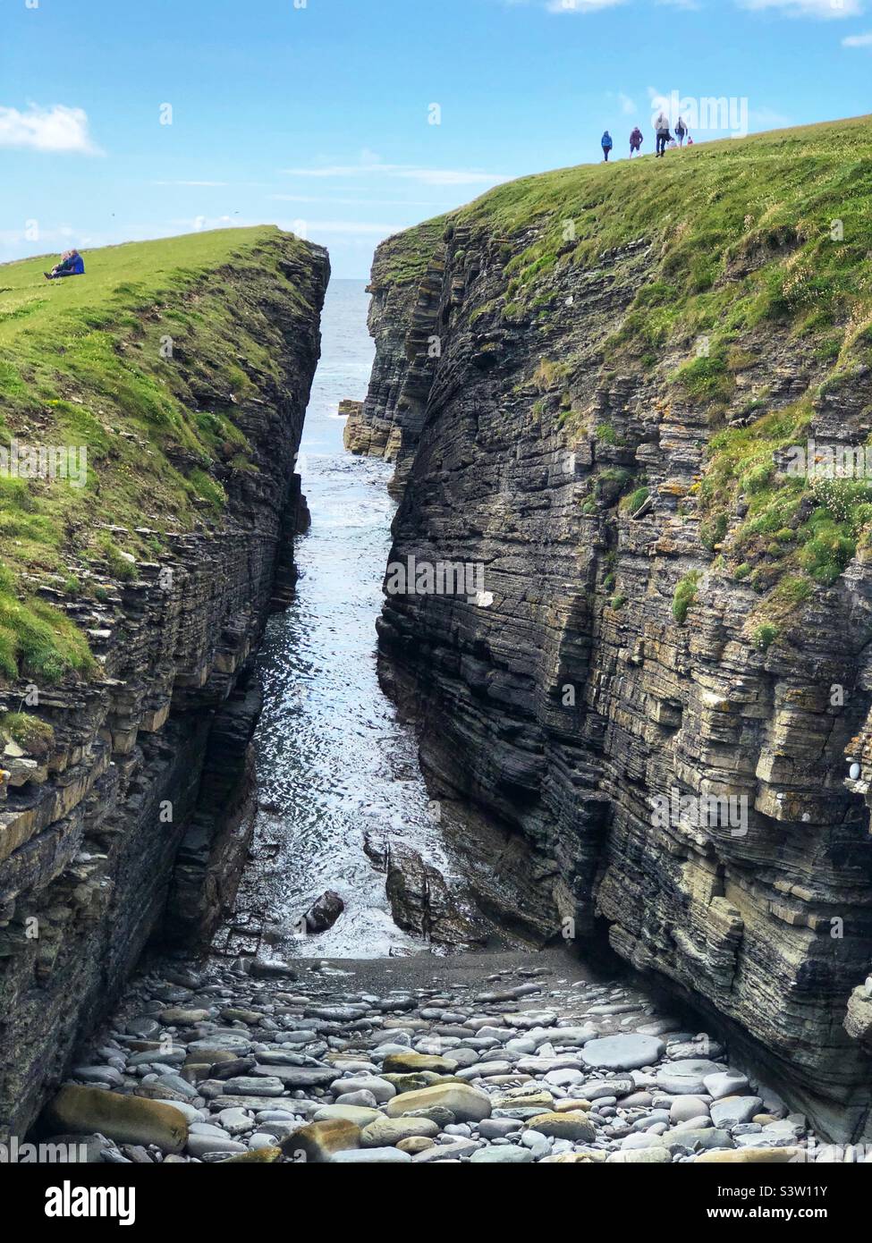 Walkers On The Coastal Path And Cliffs At The Brough Of Birsay Isle Of 
