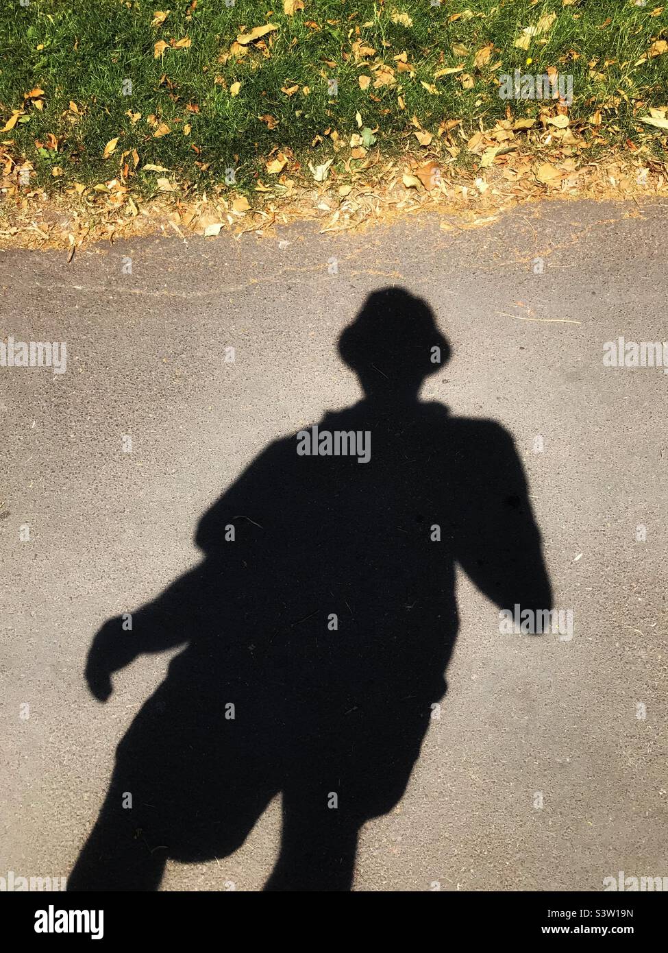Silhouette of a man wearing a hat on a hot sunny summer day - Smartphone Captured Stock Image
