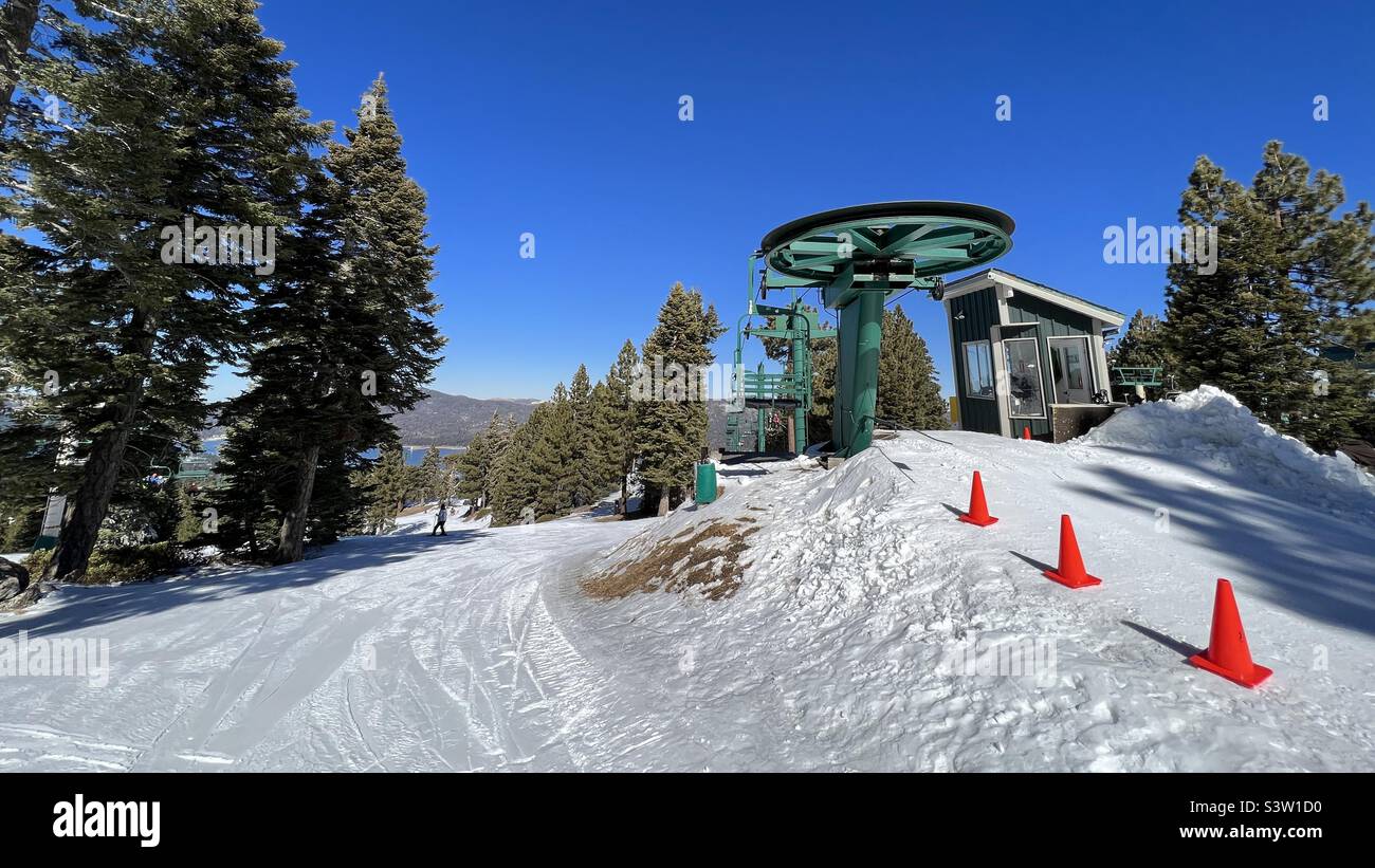 Top of chair lift with orange cones to mark exit path for skiers and snowboarders at Big Bear Mountain, California - Smartphone Captured Stock Image