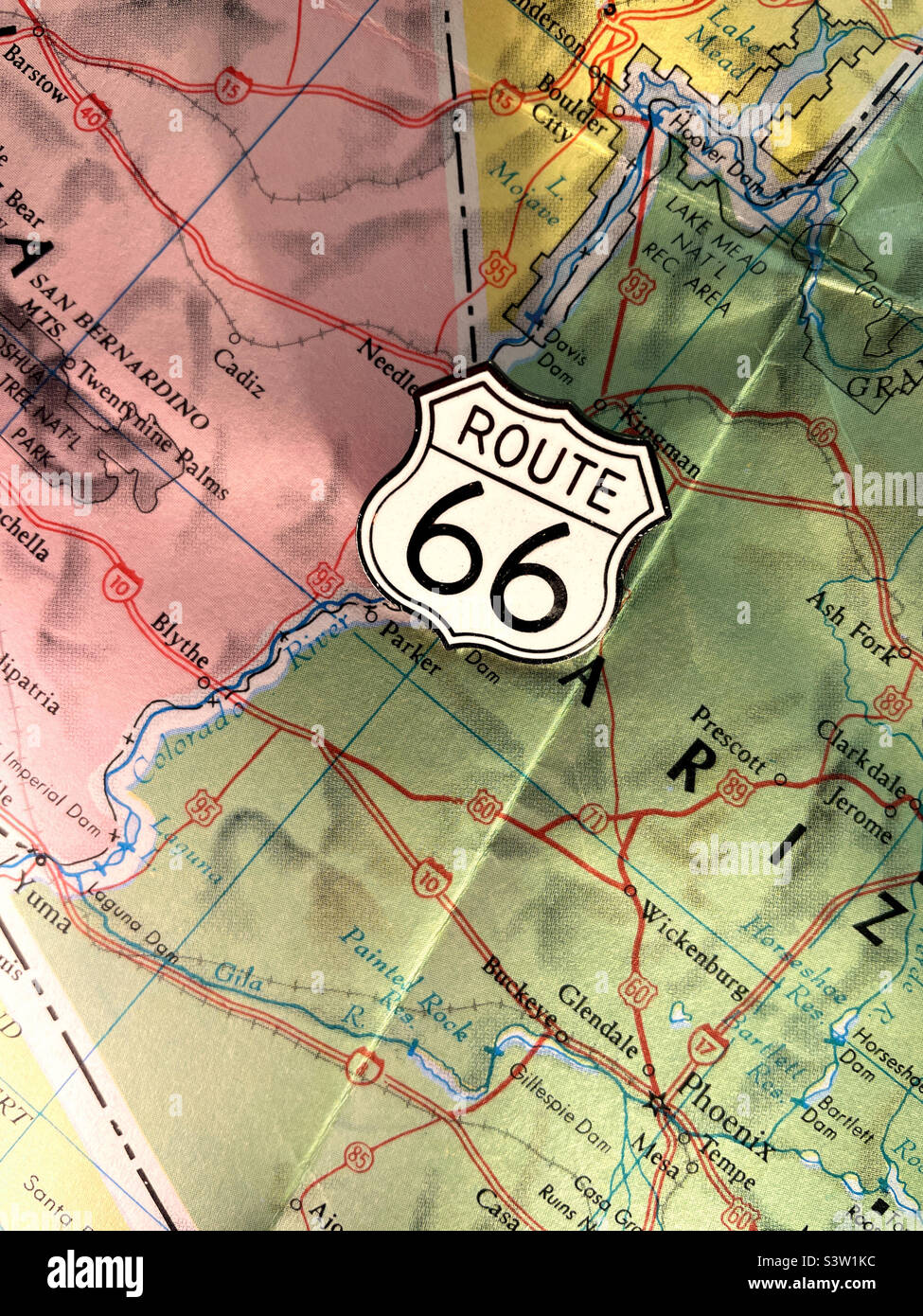 Still life of a route 66 metallic pin on a highway map, western states, 2022, USA - Smartphone Captured Stock Image