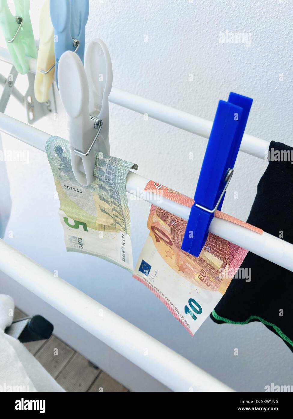 Euro notes drying out on a line Stock Photo