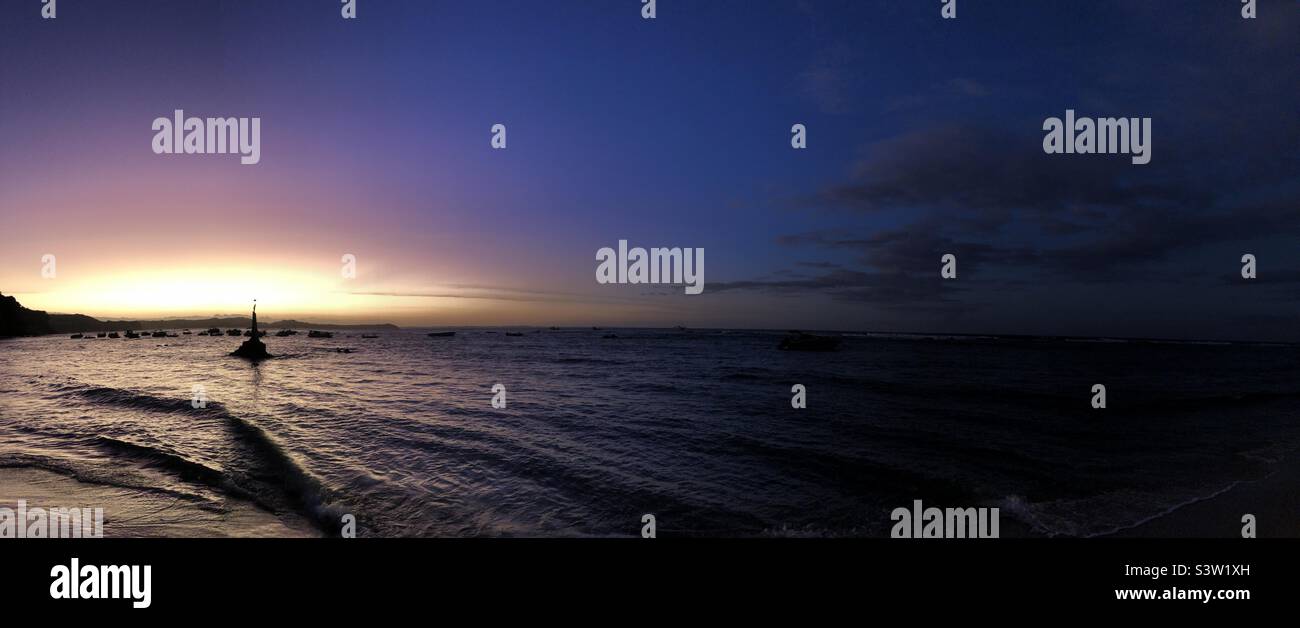 A panoramic view of the night sky by the sea. Stock Photo