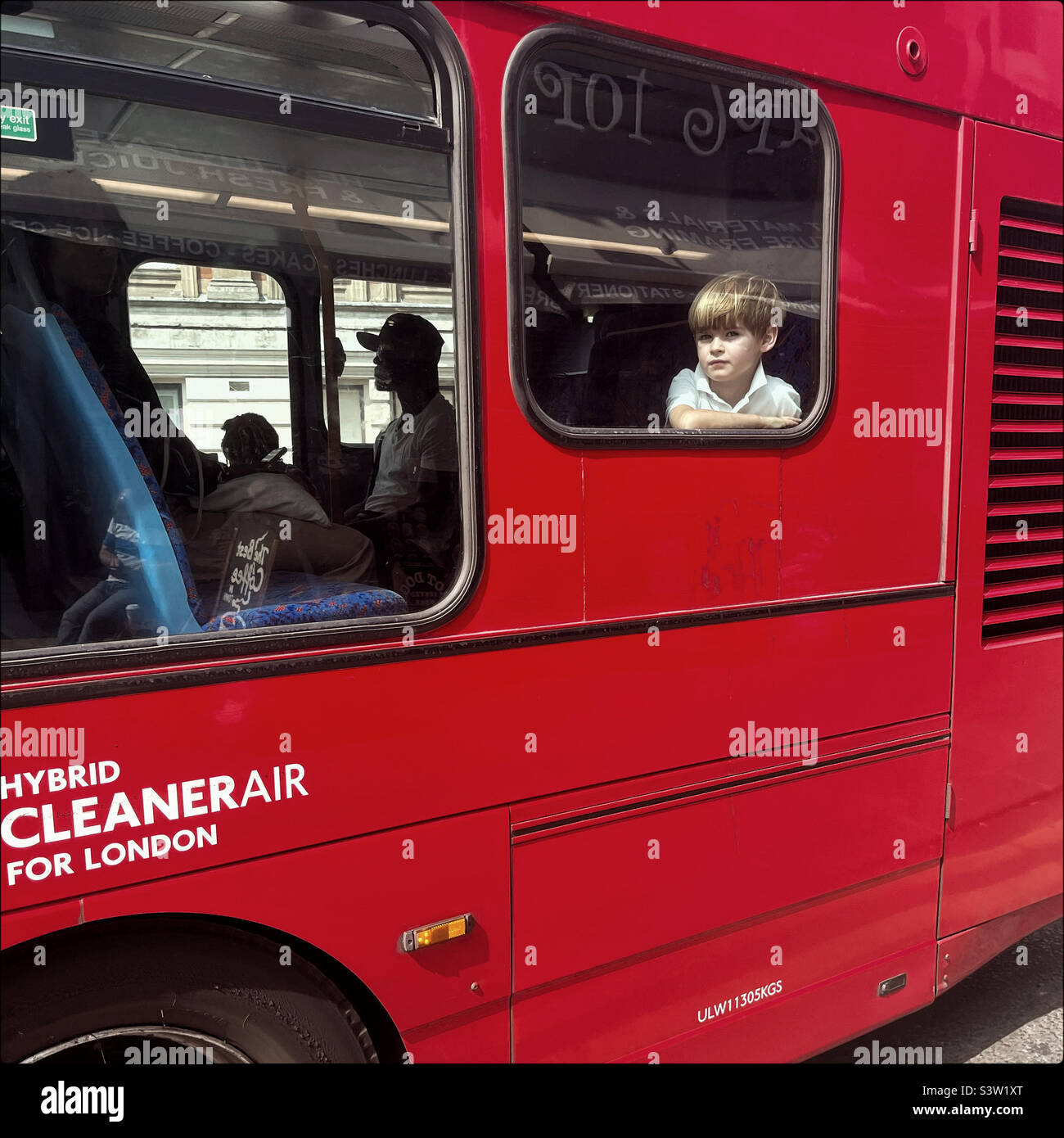Boy looks through the window of a London bus - Smartphone Captured Stock Image