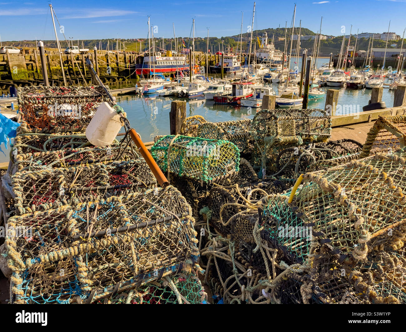 Lobster creels stacked at the side of the harbour, South Bay, Scarborough, UK - Smartphone Captured Stock Image