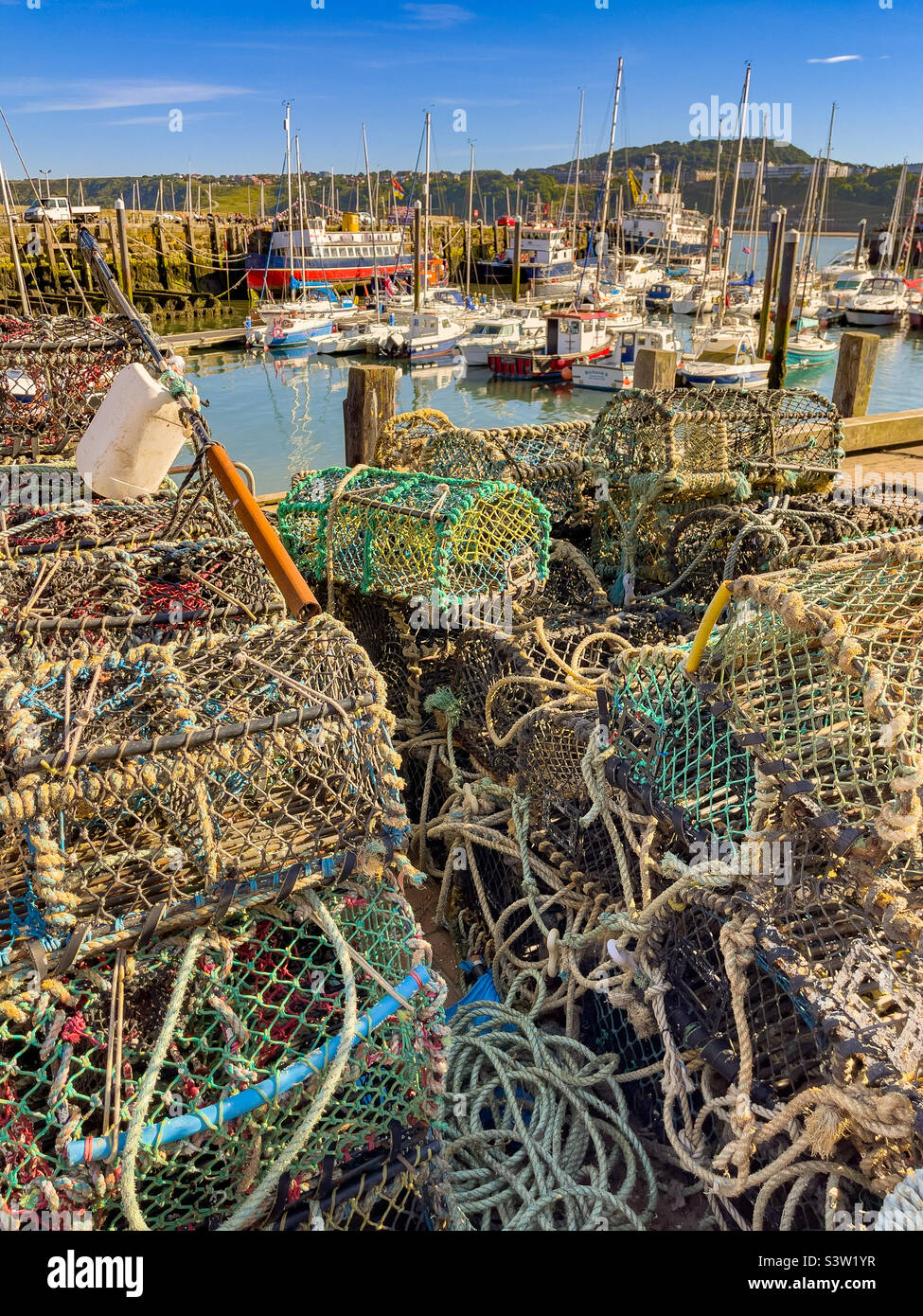 Lobster creels stacked at the side of the harbour, South Bay, Scarborough, UK - Smartphone Captured Stock Image