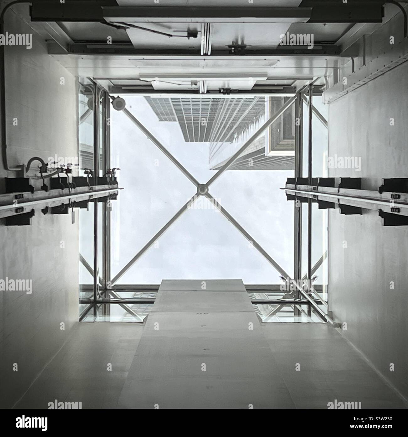 Looking up at sky and skyscrapers in California Plaza, Downtown, Los Angeles, from inside an elevator with a glass roof - Smartphone Captured Stock Image
