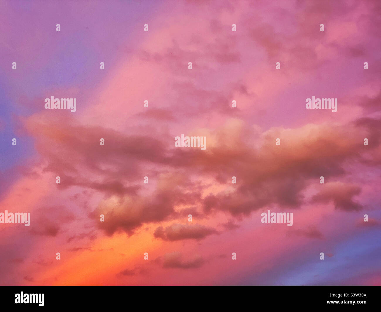 Clouds in a vibrantly colourful sky at sunset. An image with the potential for multiple uses? Photo ©️ COLIN HOSKINS. - Smartphone Captured Stock Image