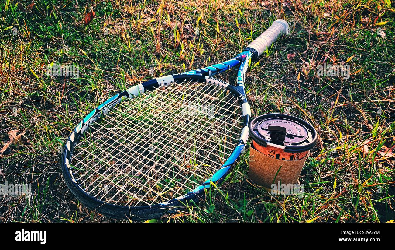 Tennis racquet and coffee on the the grass - Smartphone Captured Stock Image